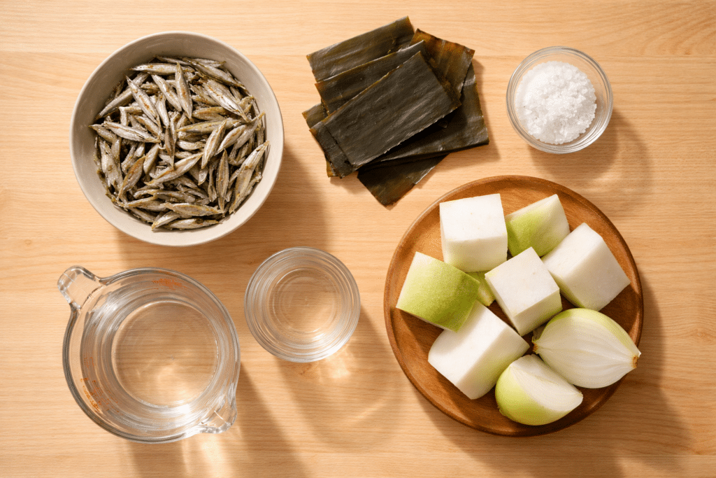 Top view of dried anchovies, kelp, radish, and other ingredients for Korean anchovy broth
